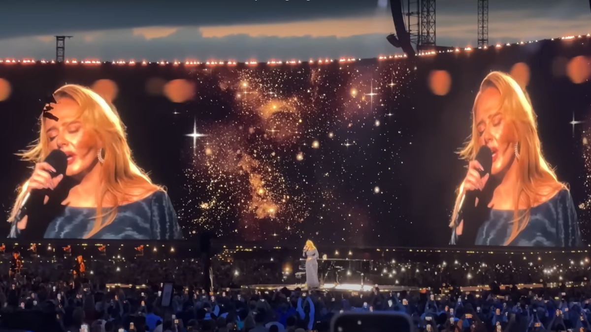 While Adele sings on a podium, a customized video show plays on the mega screen in the background. (Photo: Screenshot/ In Concert)