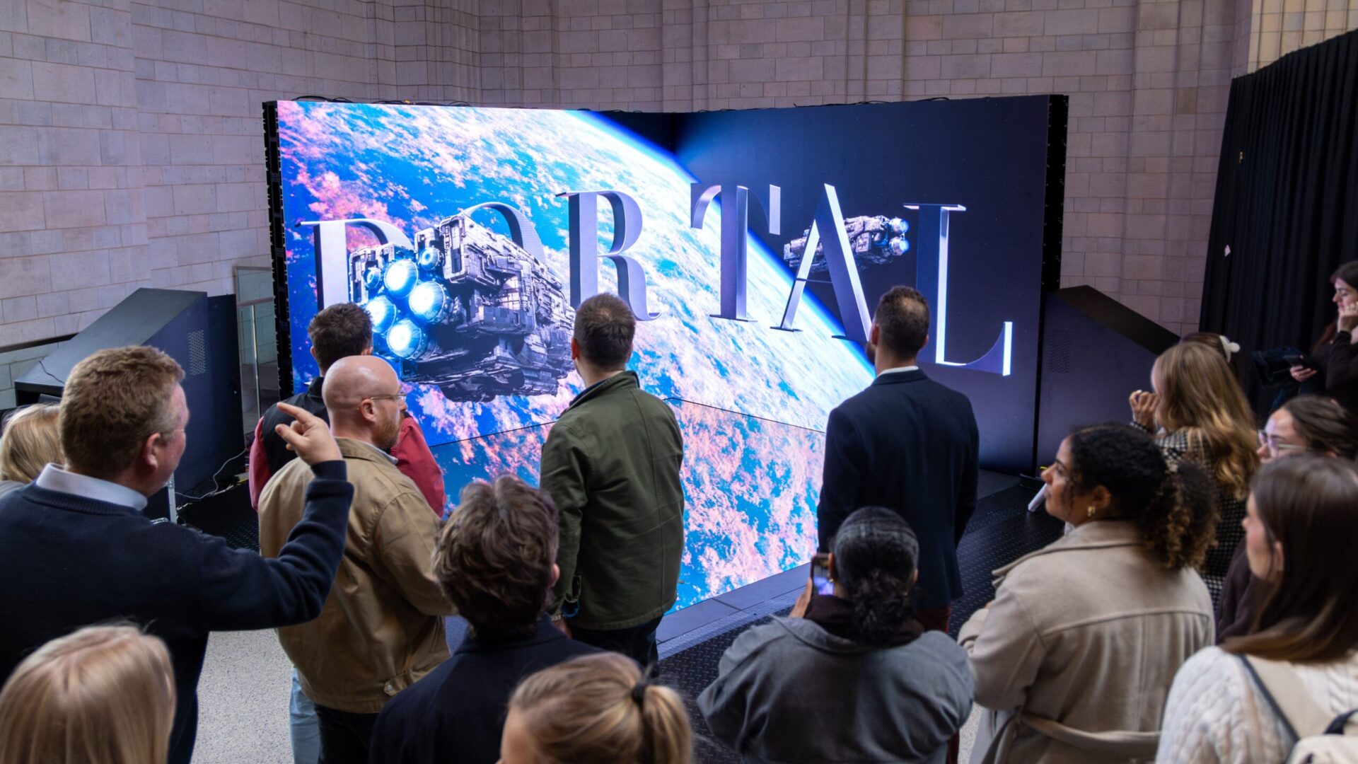 Audience gathers around Ocean Portal at Battersea Power Station as the LED installation shifts from interactive gameplay to cinematic brand content (Image: Ocean Outdoor)
