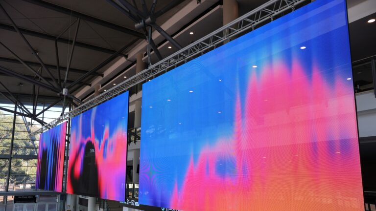Transparent LED displays suspended above the Grand Foyer form the centerpiece of Afterpay Arena's venue-wide digital signage upgrade (Image: Outsource Resource)