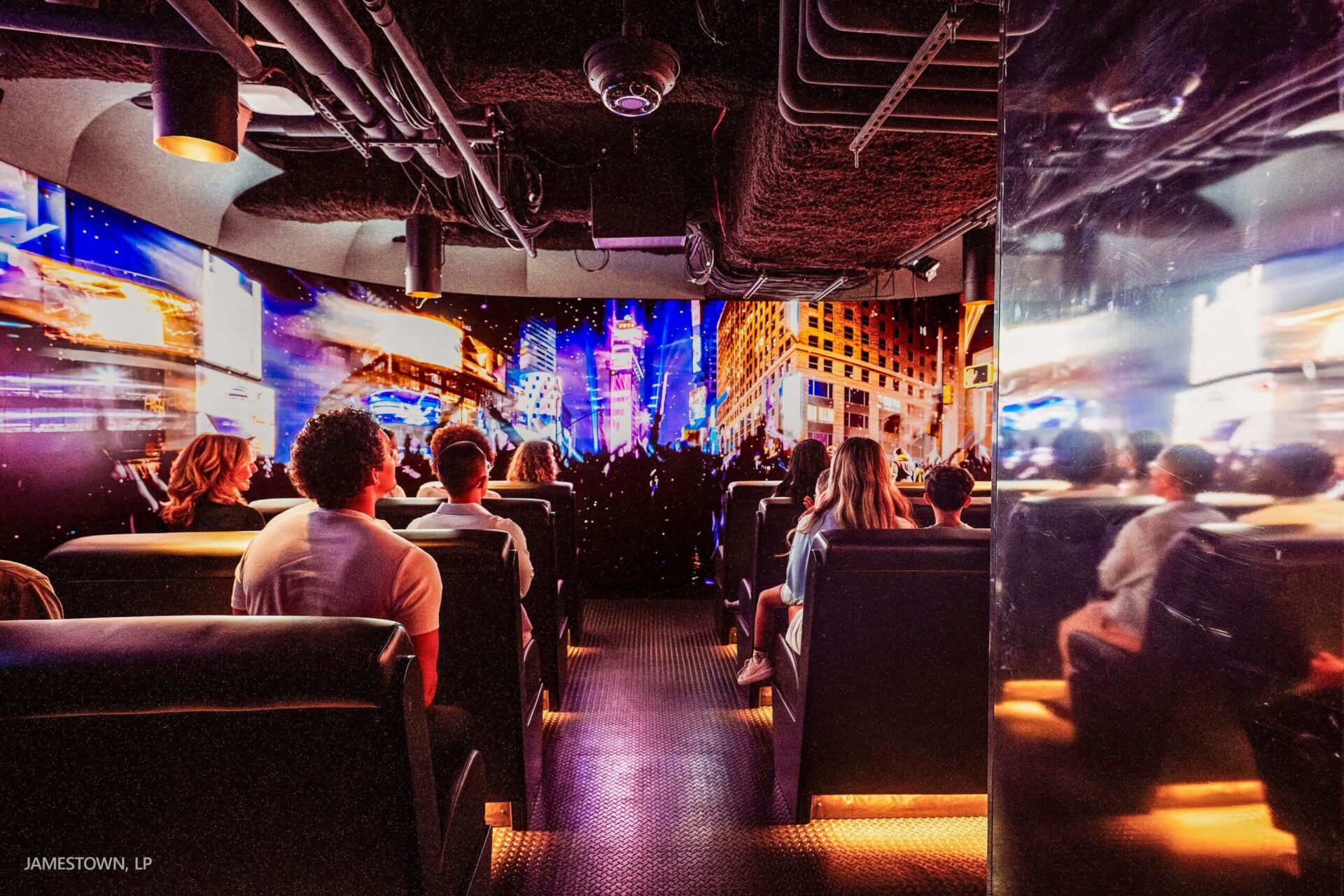 Visitors experience Times Travel’s immersive digital storytelling inside One Times Square, with LED displays surrounding the attraction’s seating area