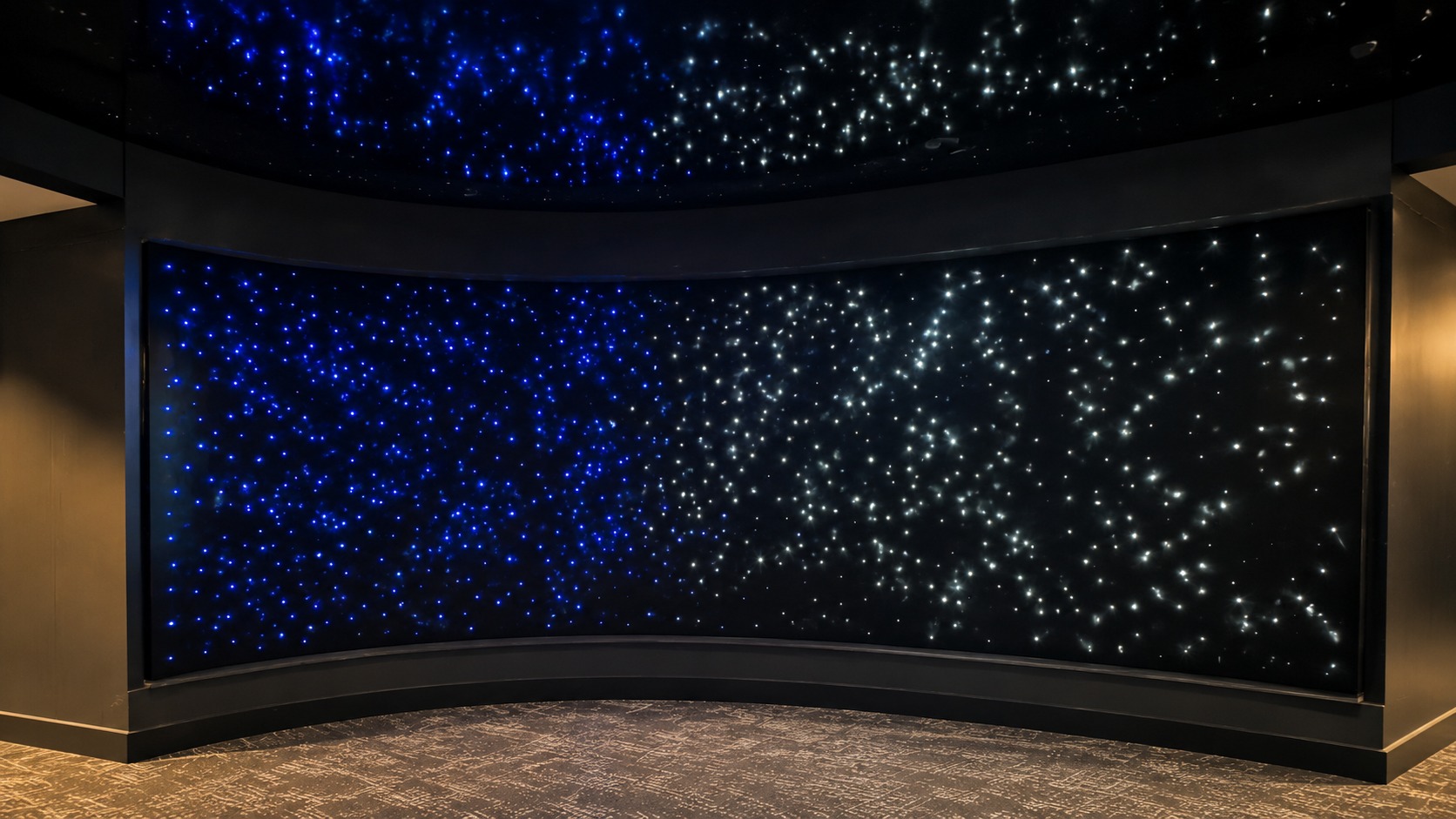 Fiber-optic points of light across the Star Chamber’s curved walls and ceiling create an immersive night-sky effect. (Image: Dimensional Innovations)