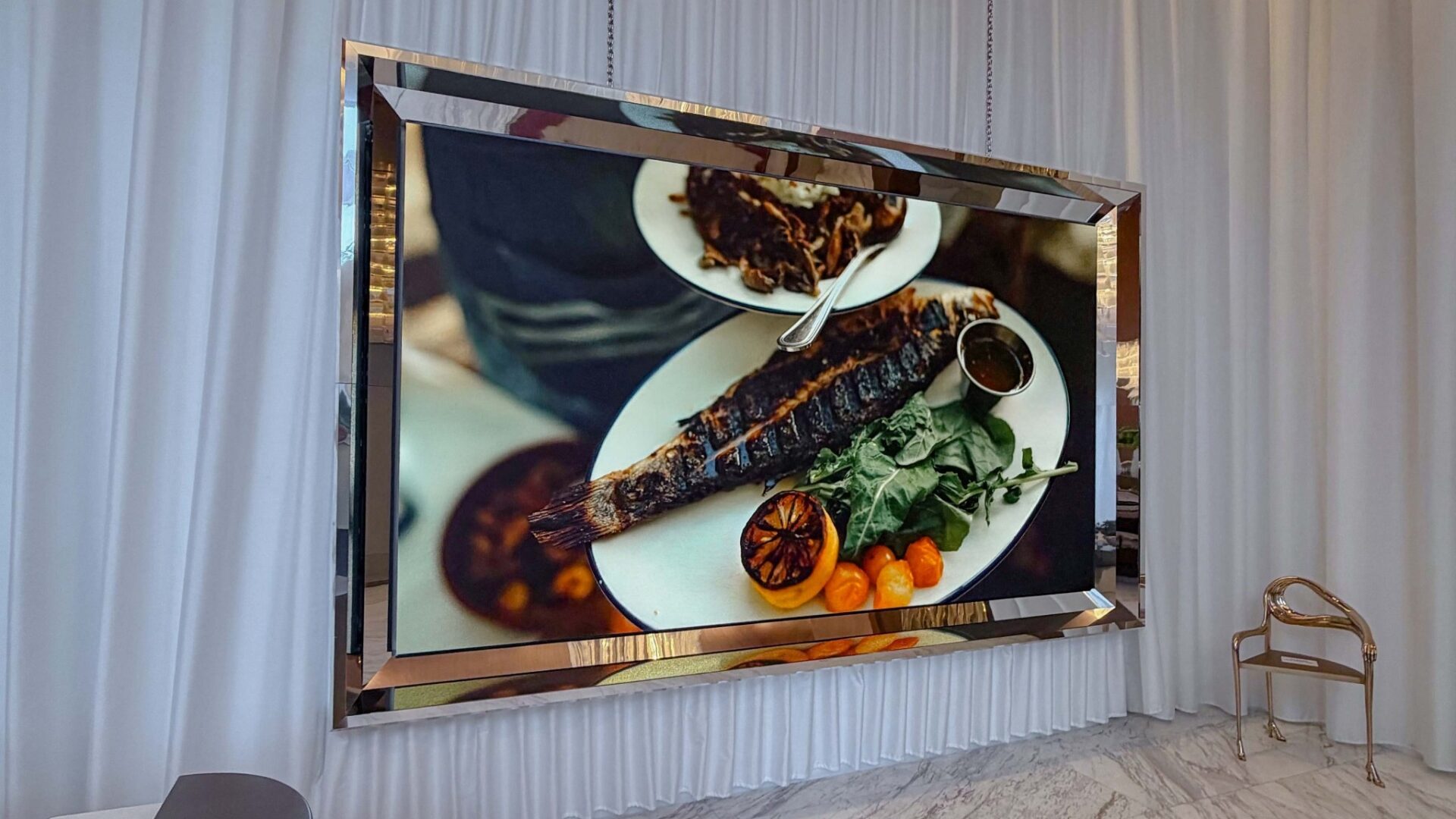 An LED display sits inside a gold-colored frame (Image: SNA Displays)