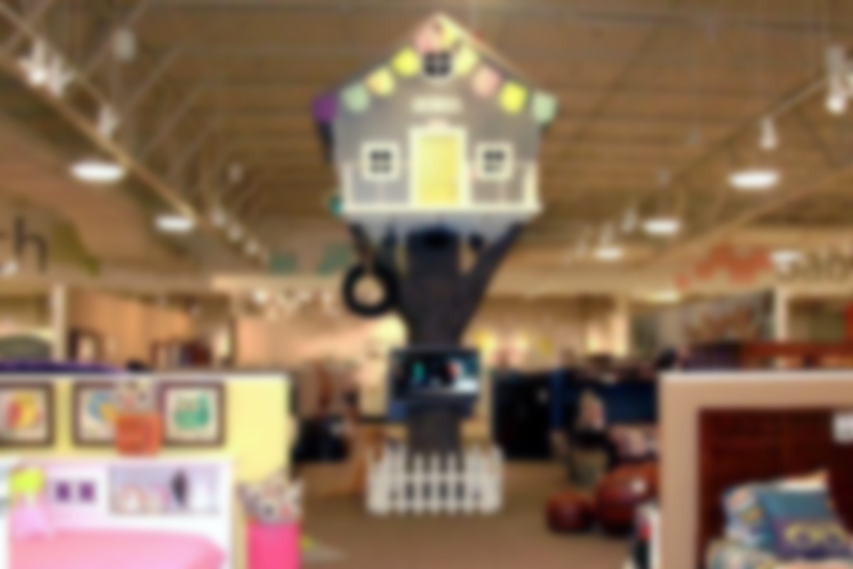 Projects: 14 Digital Experiences In Giant Nebraska Furniture Mart - 40" Samsung displays mounted to a decorative trunk of a Tree House