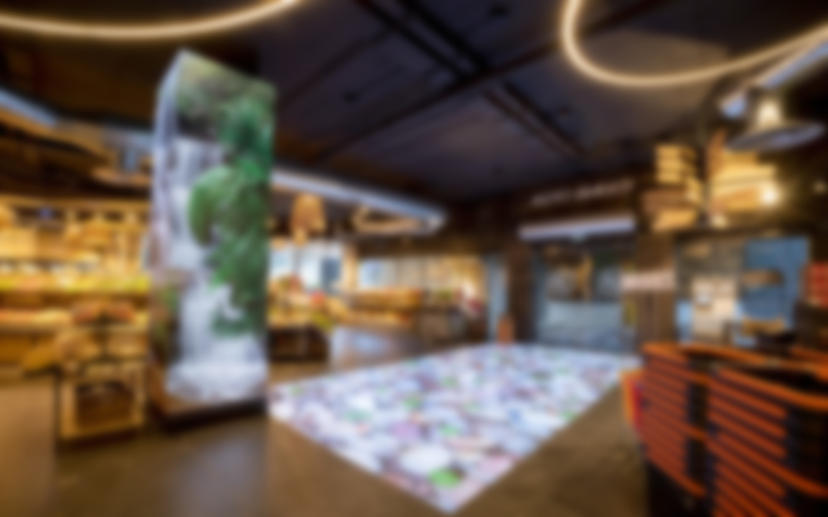 Grocer In Andorra Uses Floor Projection, LED-Wrapped Column To Create Entryway Experience