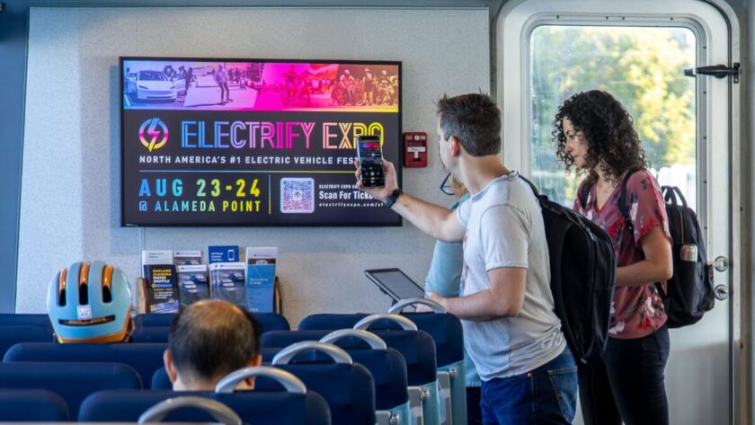 A San Francisco Bay Ferry rider engages with Ballyhoo Media’s new premium DooH network