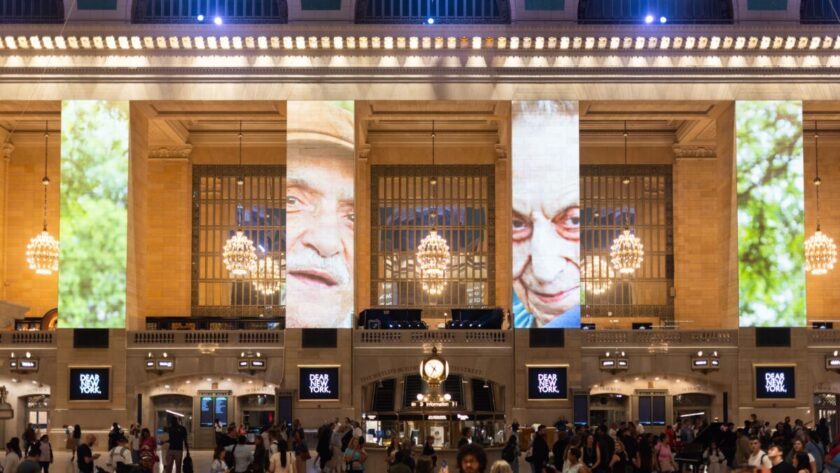 The faces of New York City loom large over Grand Central Station